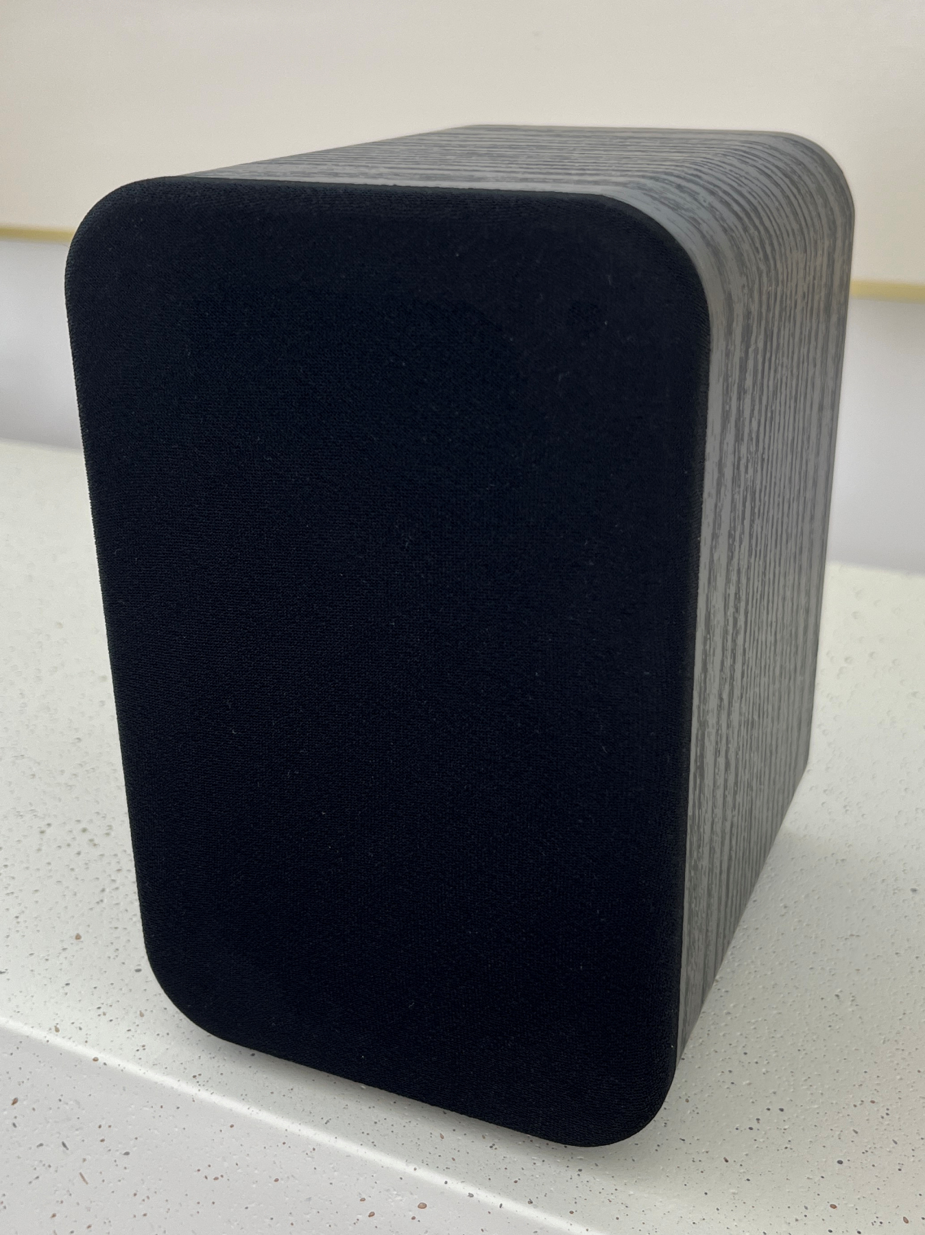 HouseWaves Two front angle view — wood grain bookshelf speaker with grille, dual driver Home Assistant audio